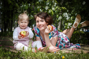 Mother and daughter with apple in the hand