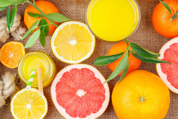 Different fruits and glass with fresh orange juice