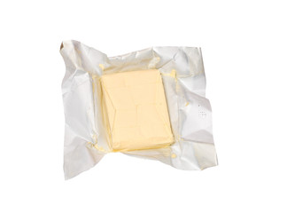 block of butter in open foil packaging isolated on white background