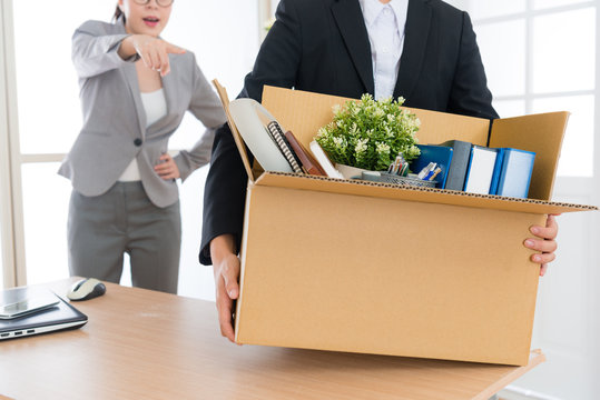 employee girl holding personal box ready to leave