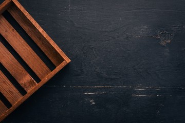 Wooden box on a black background. Top view. Copy space.