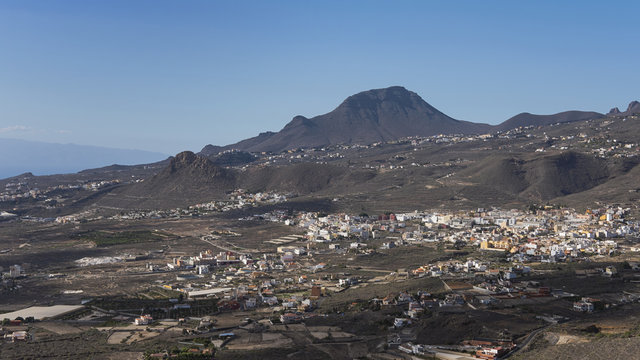 Views from Mirador La Centinela towards Valle San Lorenzo village, mountain formation Roque del Conde, and the island of La Gomera in the background, in Tenerife, Canary Islands, Spain