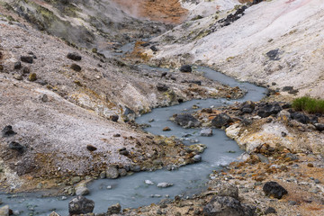Obraz premium Small river streams through the rocks of Hell Valley (Jigokudani), Noboribetsu, Hokkaido, Japan