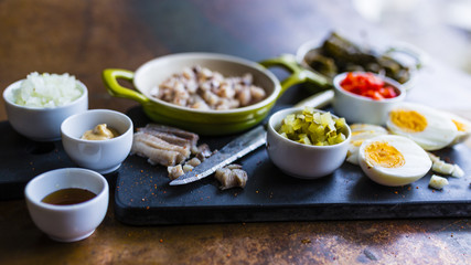 Fototapeta na wymiar Herring and chopped ingredients for herring tartare.