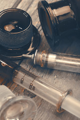 Old laboratory glassware on the hardwood background