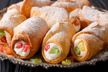 Sicilian baking cannoli with cheese cream and candied fruits macro. horizontal