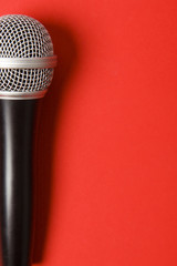 microphone on a bright red background.