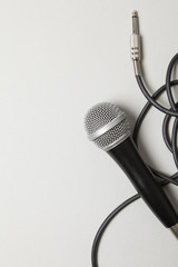 microphone and lead on a plain grey background. - obrazy, fototapety, plakaty