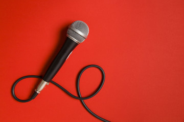 microphone and lead on a bright red background. - obrazy, fototapety, plakaty