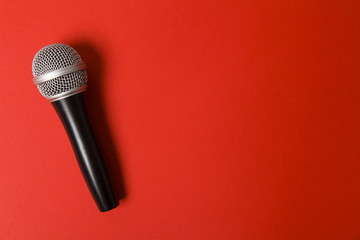 microphone on a bright red background.