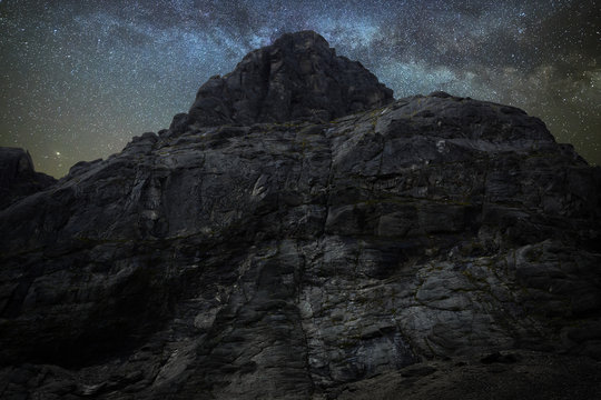 Night starry sky. Milky Way over a mountain peak.