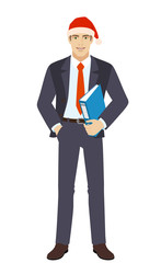 Businessman in Santa hat with hand in pocket holding a folder