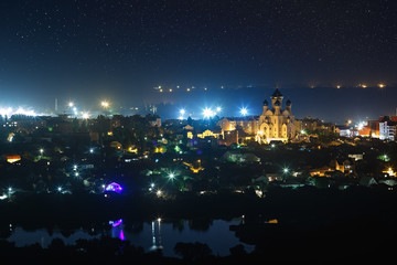 Starry night sky over the city.
