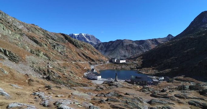 Alpine town, Cinema 4k vertigo effect view of a village in the mountains in harsh nature on the top of grand san bernardino pass, on a sunny autumn october day, Switzerland