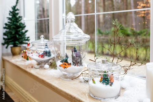 new years and christmas decorations on the windowsill of a panoramic loft window candles - Window Sill Christmas Decorations new years and christmas decorations on the windowsill of a panoramic loft window candles - Window Sill Christmas Decorations