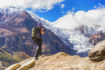 Fototapeta premium Travel concept. Hiker with backpack enjoing view on beautiful mountains.