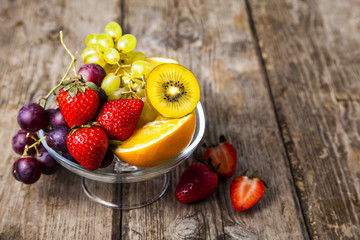 Ripe fruits on a transparent plate