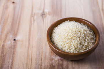 Raw rice in a wooden bowl