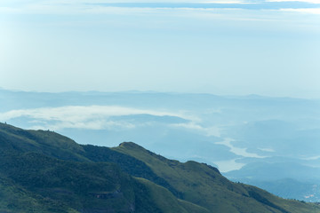 Obraz premium Sunrise in meadows and mountains landscape, Worlds End in Horton Plains National Park Sri Lanka.