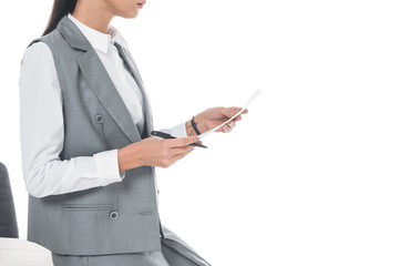 cropped image of businesswoman leaning on table and holding documents isolated on white