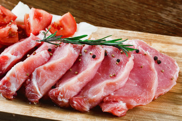 Slices of meat being seasoned for preparation.