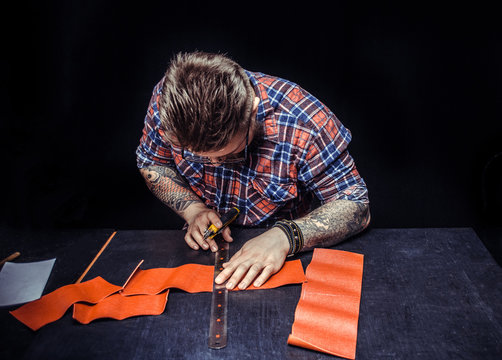 Artisan Cutting Leather With Knife