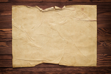 rumpled manuscript on the wooden table background