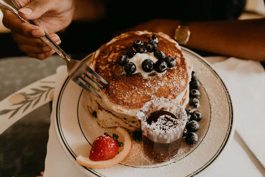 Woman having pancakes dessert