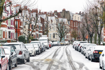 Terraced street covered with snow around West Hampstead area in London