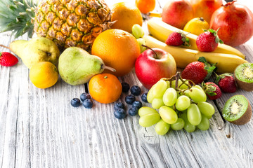 Fresh fruits on wooden background