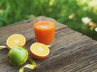Fresh orange juice and variety of fresh on wooden table.