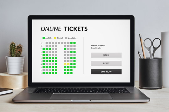 Online tickets concept on laptop screen on modern desk. All screen content is designed by me. Front view.