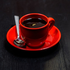 coffee in a red mug on a black wooden background