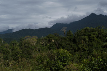 landscape of mountains with clouds on the peak