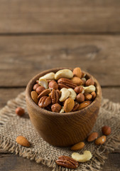 mixed nuts on wooden surface