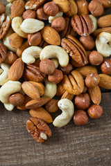 mixed nuts on wooden surface