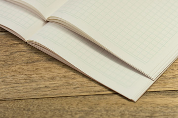 Stack blank notebook on wooden table for learning Japanese language writing words.