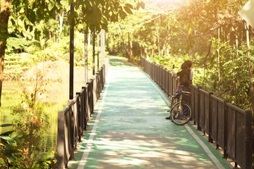 Couples are couple photos in biking path at the public park with sunset. Concept love in valentines ‘day.