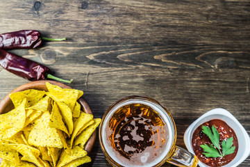 Nachos corn chips with classic tomato salsa. Fresh cold beer is perfect with savory snacks.