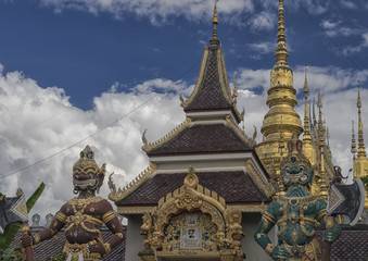 Demon guards at a temple near Lampang Thailand