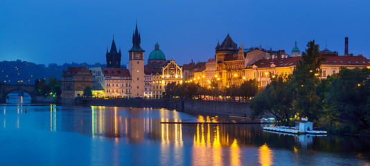 Night view of famous european Prague city - the capital of Czech republic with reflection in river Vltava