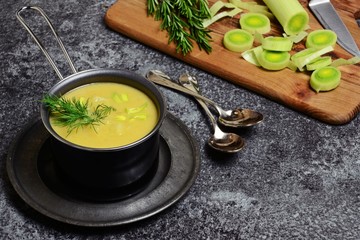Delicious leek and potato soup on the dark background
