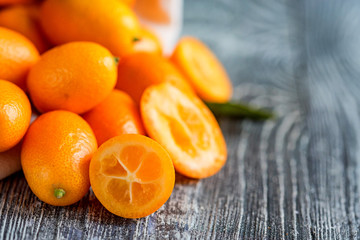 Kumquat or cumquat on wooden table