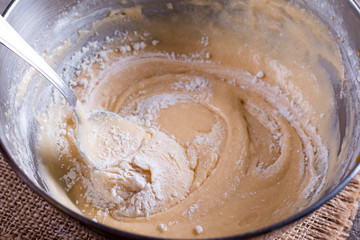 Dough for cake in a metal bowl