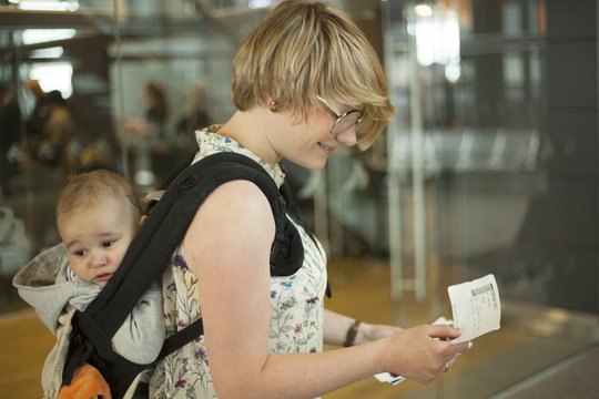 Mother and child in baby carrier at the airport