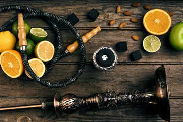 Stylish Smoking hookah and basket with lemon, lime and orange on