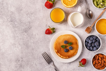Pancakes with fruit, honey, nuts.