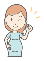 A pregnant woman in green's clothes is lifting his fist with a smile