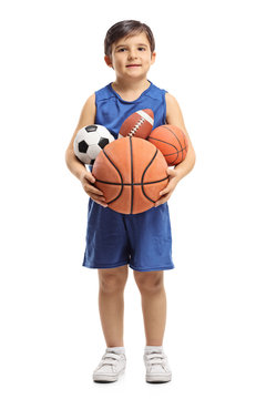 Little boy holding sports balls