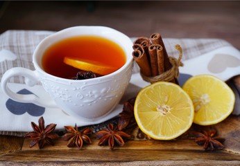 Hot tea in white cup with lemon. Selective focus, top view. Still life, food and drink, seasonal and holiday concept
